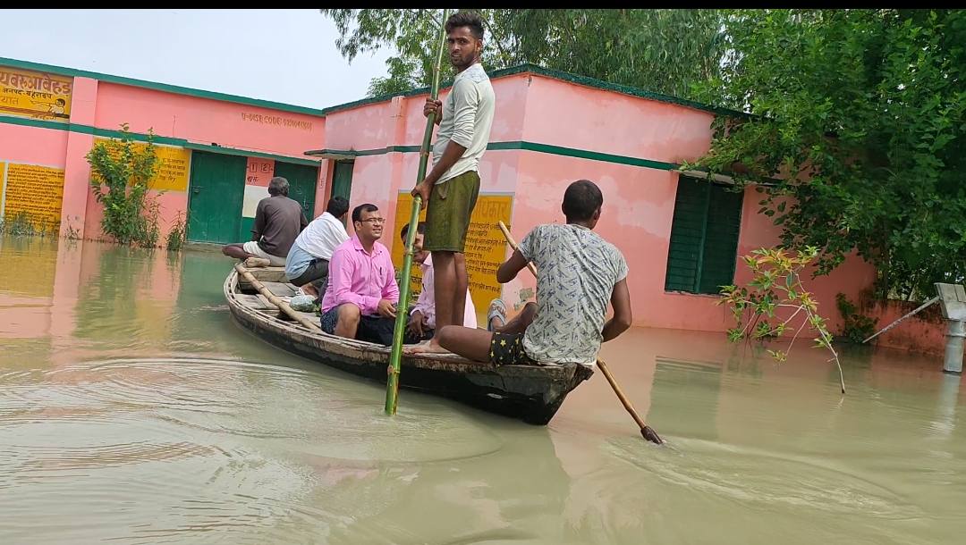 शिक्षक नाव में बैठकर विद्यालय पहुंचे ।